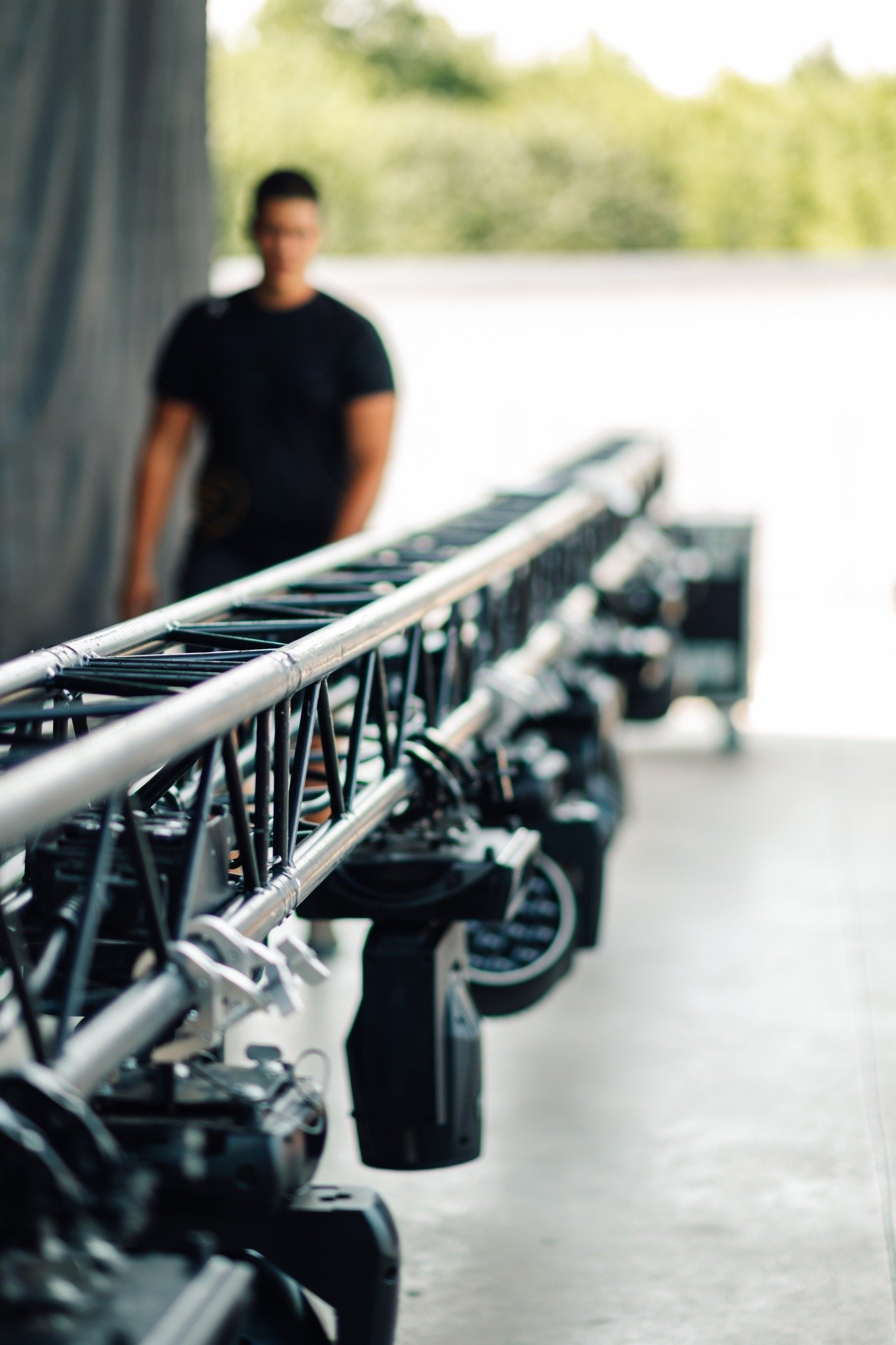 Lighting technician setting up a lighting system for a concert or event